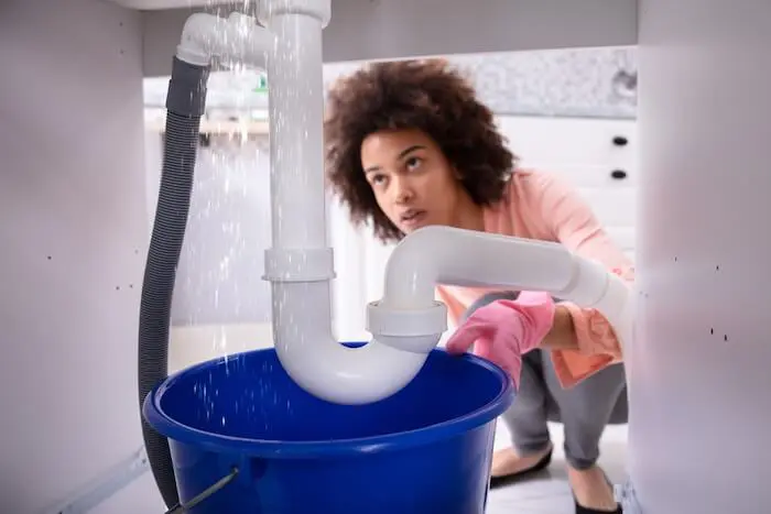 Leaking pipe under kitchen sink