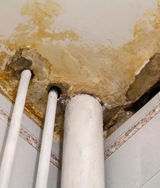 Ceiling water damage with pipes